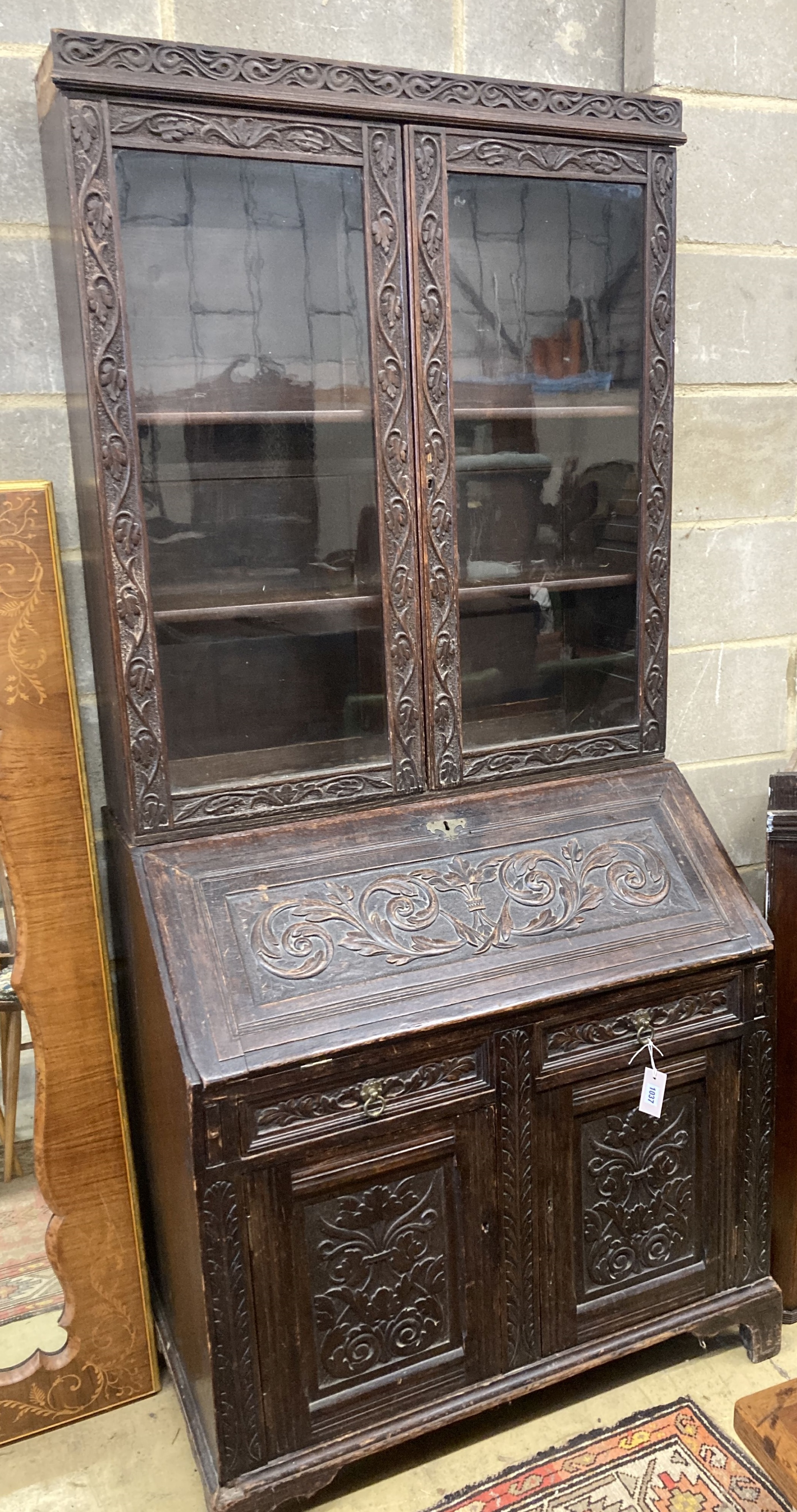 A Victorian carved oak bureau bookcase, width 94cm, depth 54cm, height 203cm